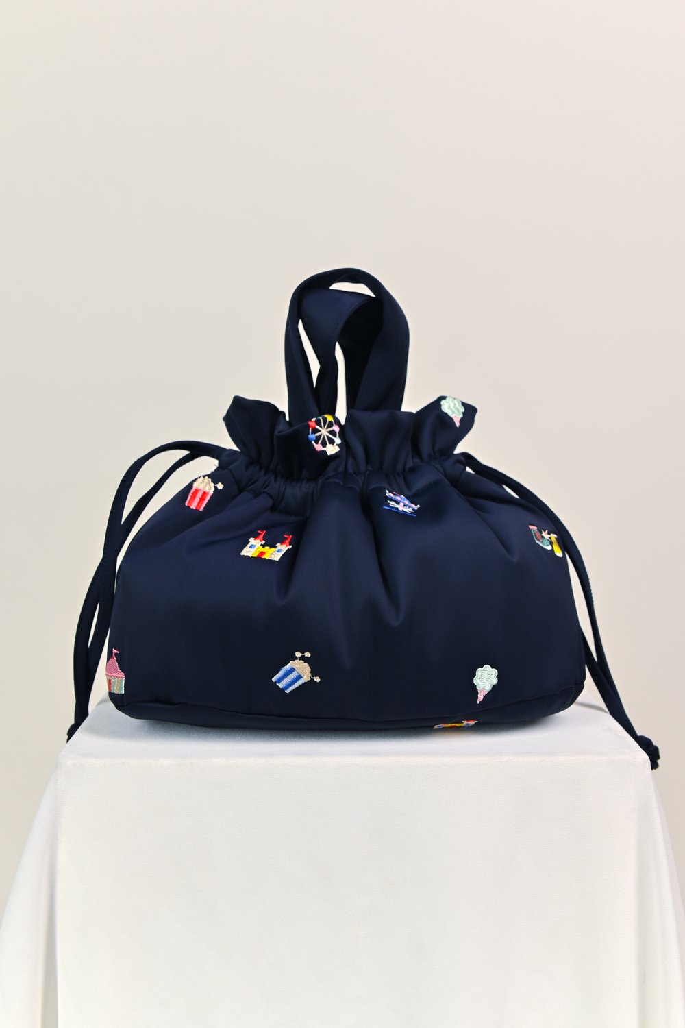 CARNIVAL NAVY EMB. PUFFY DUMPLING BAG CARNIVAL NAVY EMB. PUFFY DUMPLING BAG