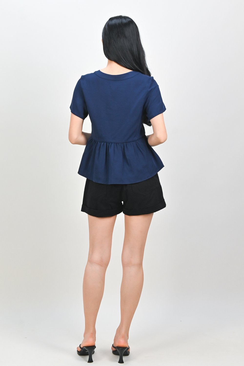 NEMIRA NOTCHED-NECK PEPLUM TOP IN NAVY